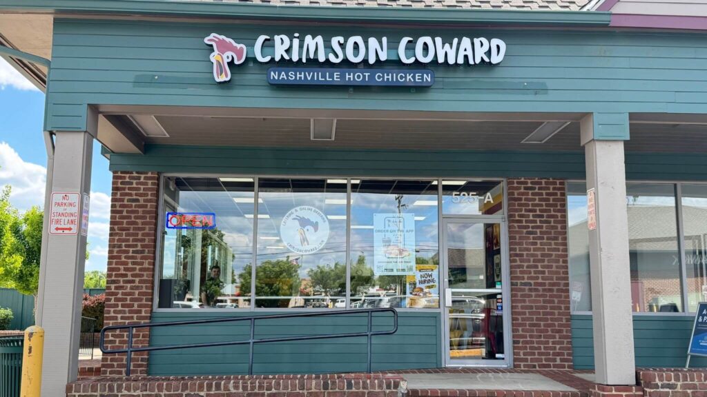 Front exterior of Crimson Coward Nashville Hot Chicken restaurant in Leesburg Virginia with storefront signage and entrance