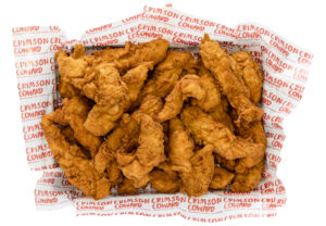 What Nashville hot chicken is — Crimson Coward halal hot chicken tenders with red cayenne crust