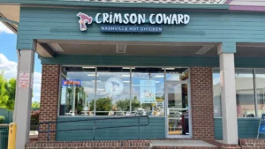 Crimson Coward Nashville hot chicken franchise storefront with branded signage and open sign